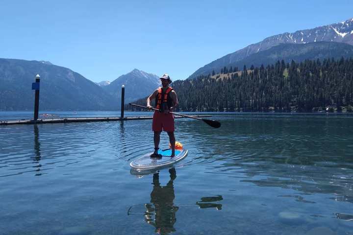 a man standing next to a body of water
