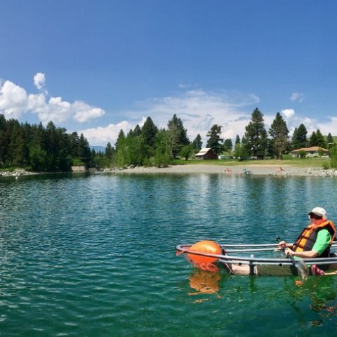 a group of people rowing a boat in the water