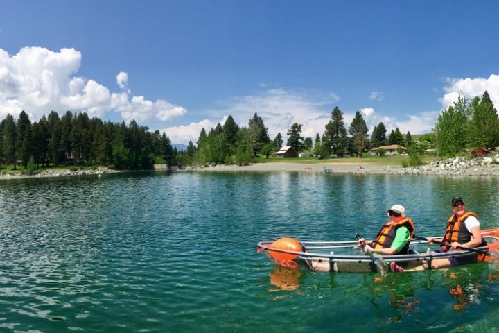 a group of people rowing a boat in the water