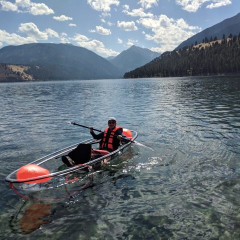 person rowing a boat in a body of water