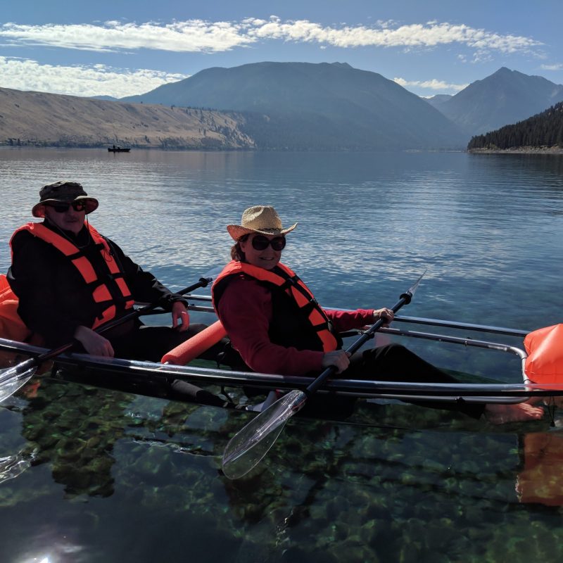 a group of people rowing a boat in a body of water