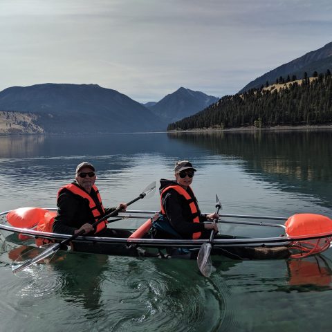 a group of people rowing a boat in a body of water