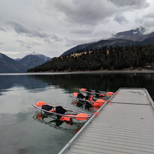a small boat in a body of water with a mountain in the background