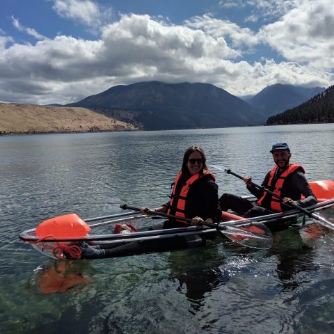 a group of people rowing a boat in a body of water