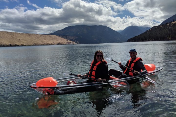 a group of people rowing a boat in a body of water