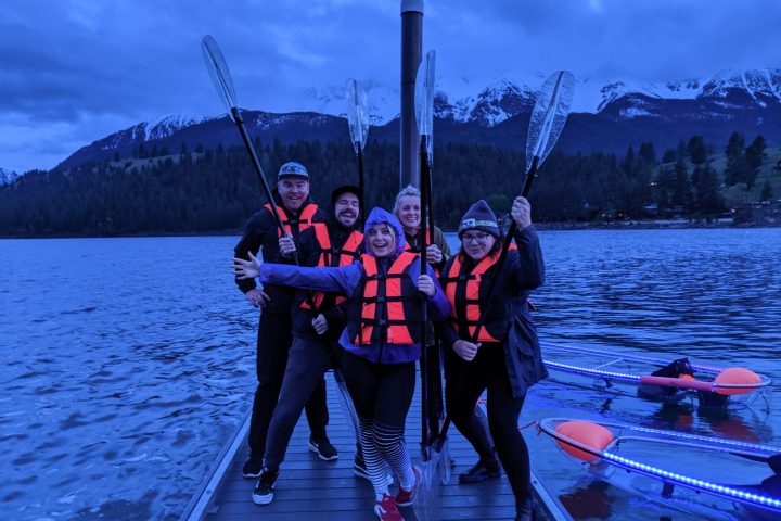 a group of people standing next to a body of water