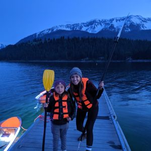 a person standing next to a body of water