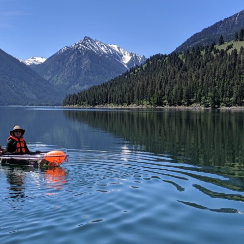a group of people rowing a boat in the water