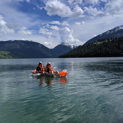 a group of people rowing a boat in a body of water