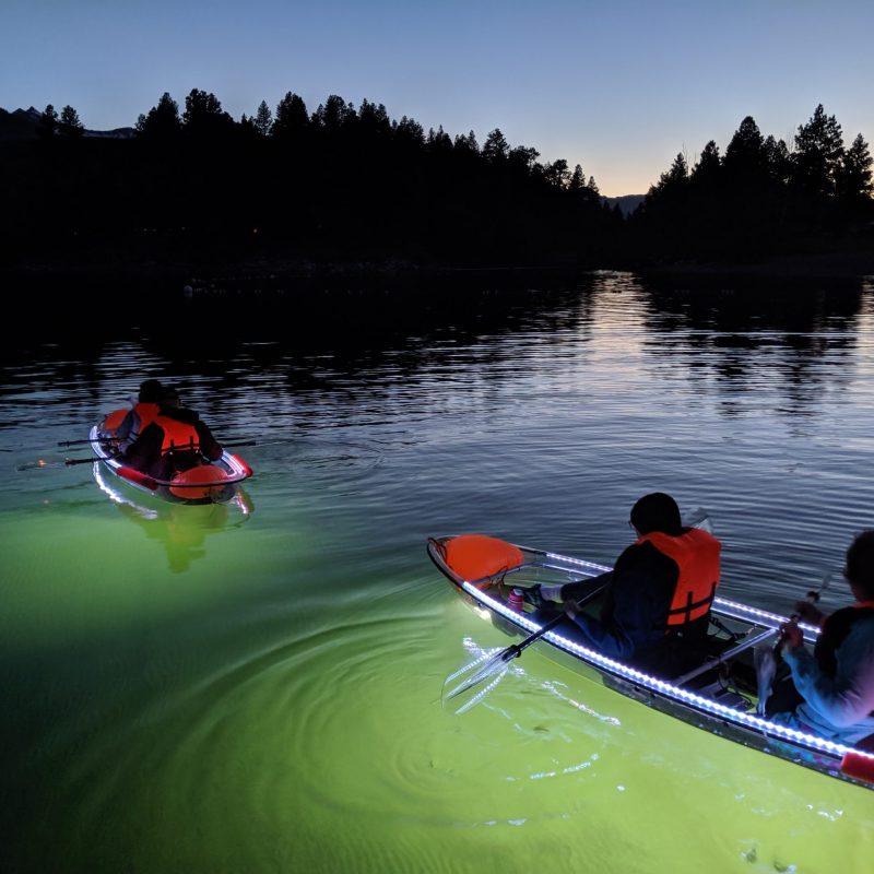 a group of people in a small boat in a body of water