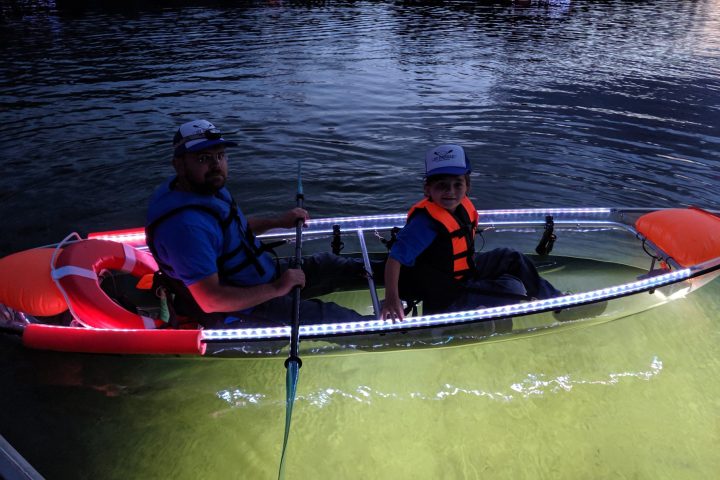 a group of people rowing a boat in the water