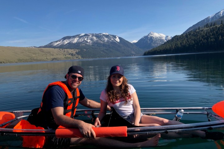 a group of people rowing a boat in a body of water