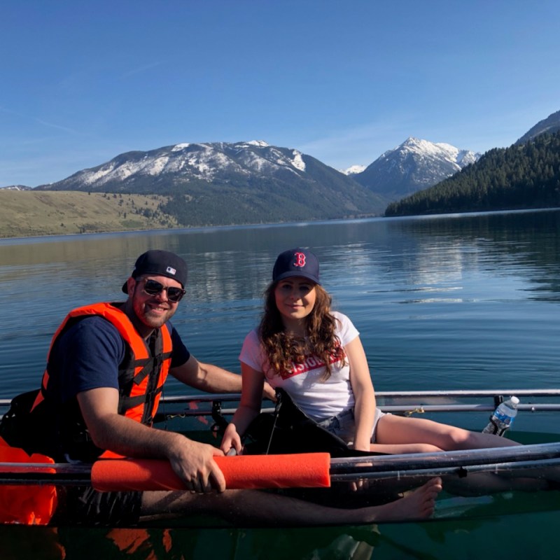 a group of people rowing a boat in a body of water