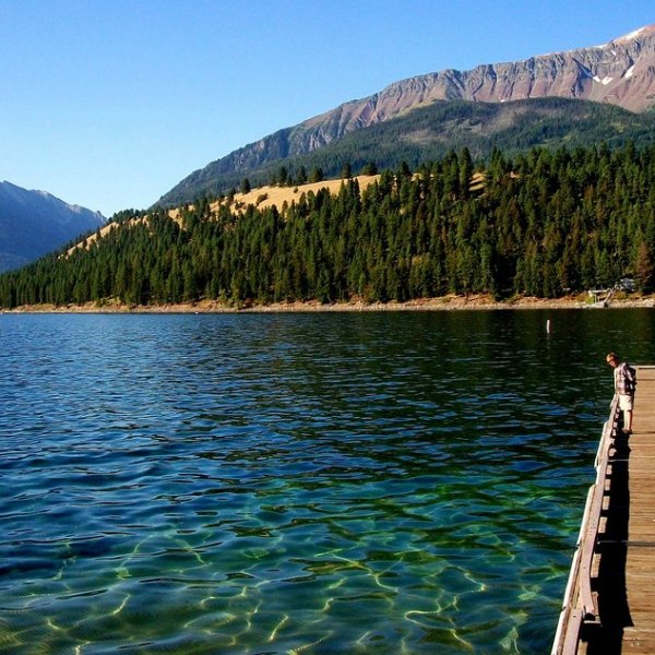 a body of water with a mountain in the background