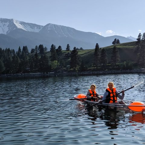 a group of people rowing a boat in the water