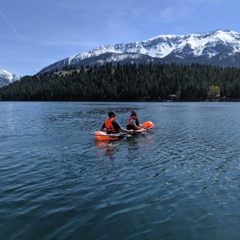 a group of people riding skis on a lake