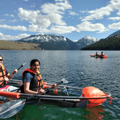 a group of people in a small boat in a body of water