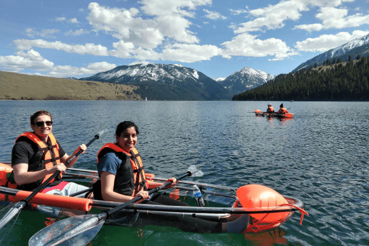 a group of people in a small boat in a body of water