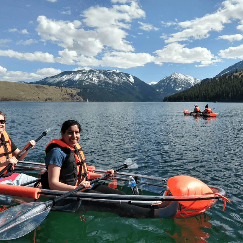a group of people in a small boat in a body of water