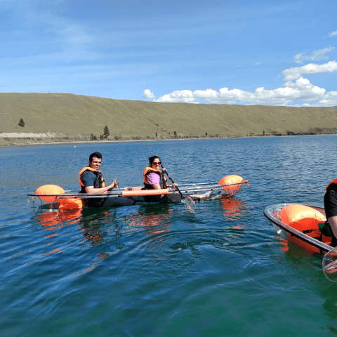 a group of people rowing a boat in a body of water