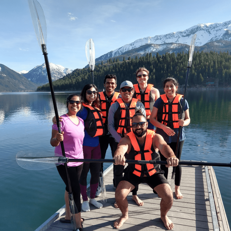 a group of people standing next to a body of water