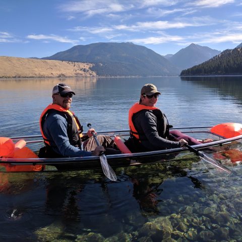 a group of people rowing a boat in a body of water