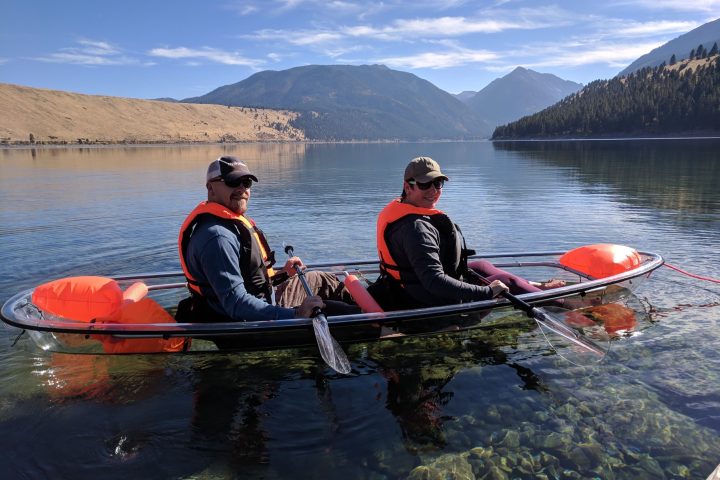 a group of people rowing a boat in a body of water