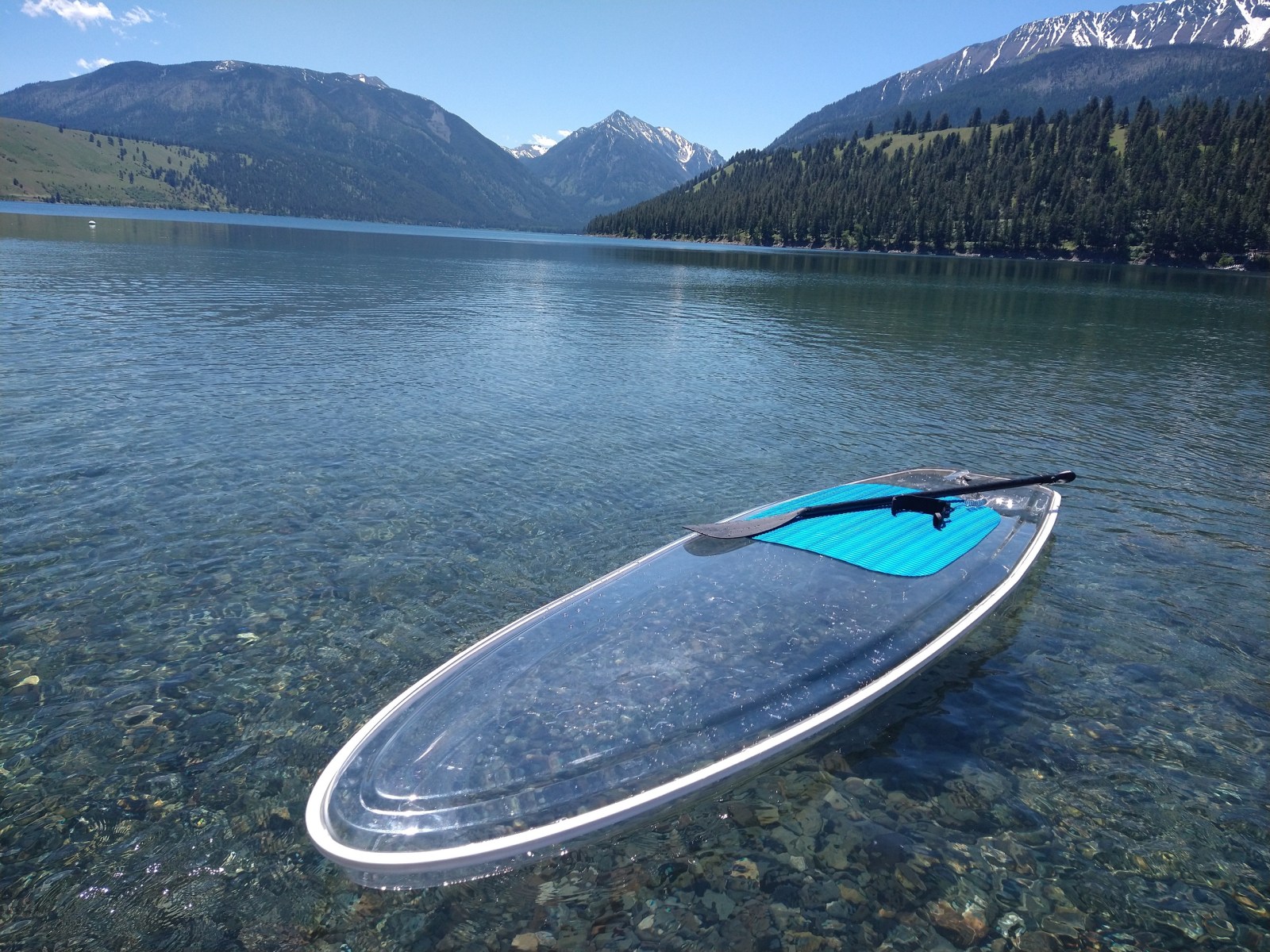 a body of water with a mountain in the background