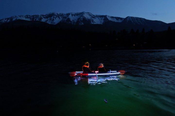 a group of people rowing a boat in a body of water