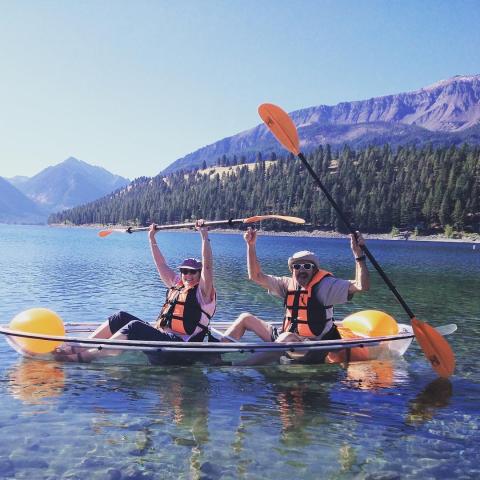 a group of people rowing a boat in the water