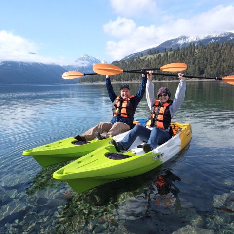 a man riding on the back of a boat in a body of water