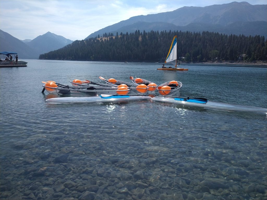 a group of people in a small boat in a body of water